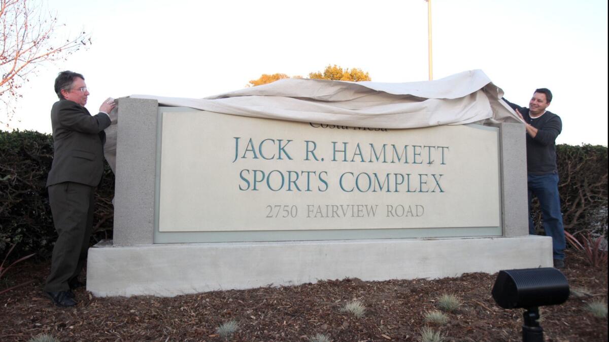 Former Costa Mesa mayor Gary Monahan, left, and current Councilman Allan Mansoor uncover the title sign during dedication and unveiling ceremony of the Jack R. Hammett Sports Complex in 2012.