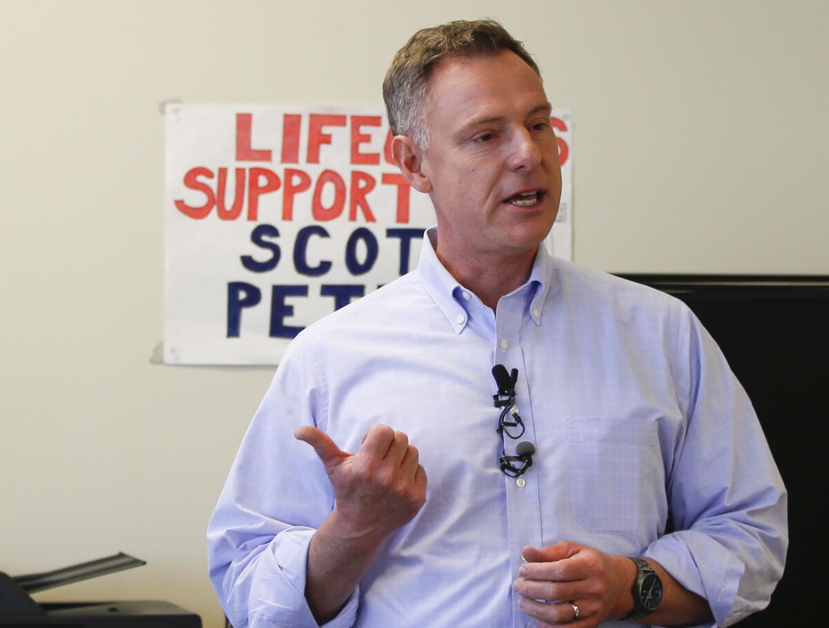 Democratic Rep. Scott Peters talks to his volunteers during the campaign.