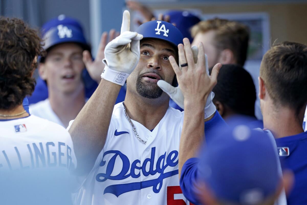 Dodgers first baseman Albert Pujols celebrates after hitting a two-run home run in the eighth inning.