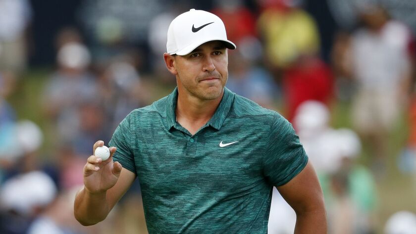 Brooks Koepka waves to the crowd after making his birdie putt on the 15th green during the final round of the PGA Championship golf tournament at Bellerive Country Club, Sunday, Aug. 12, 2018, in St. Louis.