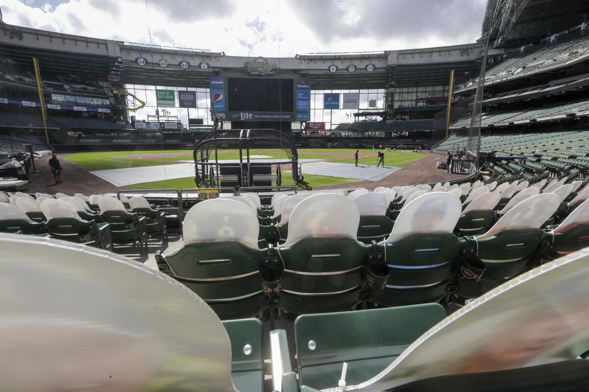 Fan cutouts are seen behind home plate at Miller Park on Friday in Milwaukee. 