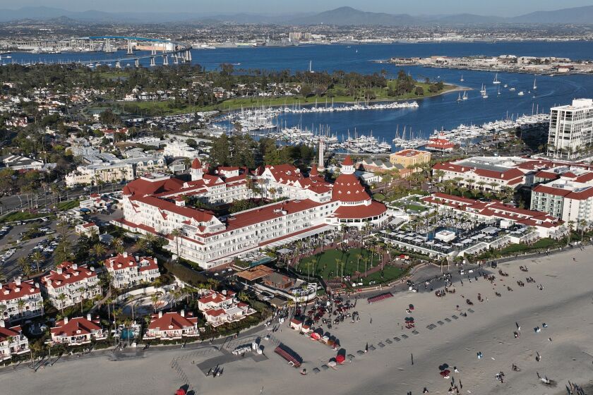 Coronado, CA - April 07: An aerial view of the historic Hotel del Coronado, beach, marina, surrounding commercial area and Coronado Bridge in the distance in Coronado Friday, April 7, 2023. (Allen J. Schaben / Los Angeles Times) The city of Coronado is in a dispute with the state of California on developing a required affordable housing plan. Despite the state passing a raft of new laws saying they'll be holding cities accountable, Coronado has been out of compliance with state law for years with little consequence.