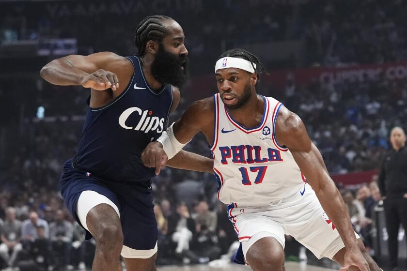Philadelphia 76ers guard Buddy Hield (17) drives past Los Angeles Clippers guard James Harden.