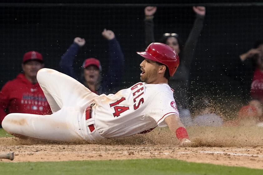 Los Angeles Angels' Tyler Wade scores on a Max Stassi walk off single during the ninth inning of a baseball game Tuesday, April 12, 2022, in Anaheim, Calif. The Angels won 4-3. (AP Photo/Mark J. Terrill)