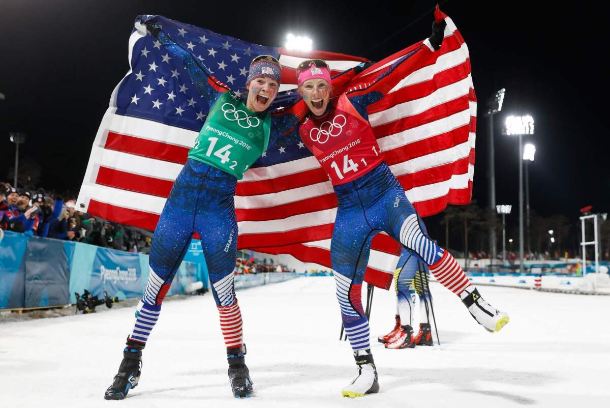 Jessica Diggins, left, and Kikkan Randall celebrate winning gold in the women's cross country team sprint free final.