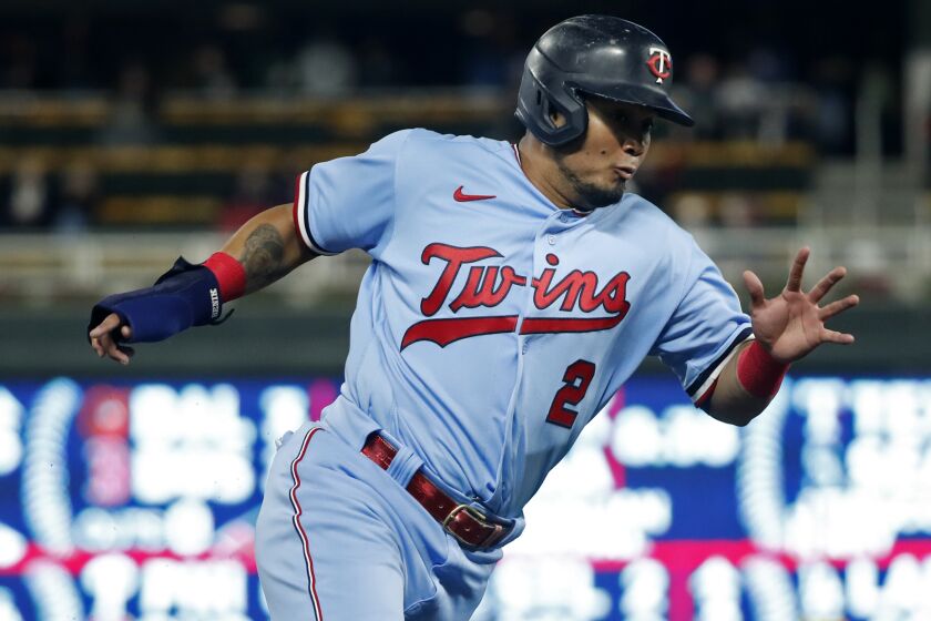 Minnesota Twins' Luis Arraez rounds third base en route to scoring against the Chicago White Sox on a double by Jose Miranda in the third inning of a baseball game Tuesday, Sept. 27, 2022, in Minneapolis. (AP Photo/Bruce Kluckhohn)