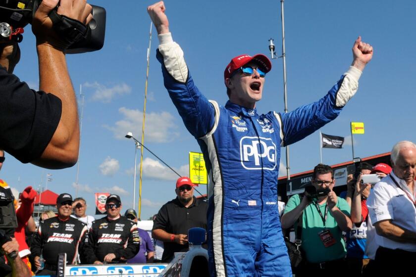 Josef Newgarden celebrates after winning the IndyCar Honda Indy 200 auto race Sunday, July 30, 2017, at Mid-Ohio Sports Car Course in Lexington, Ohio. (AP Photo/Tom E. Puskar)