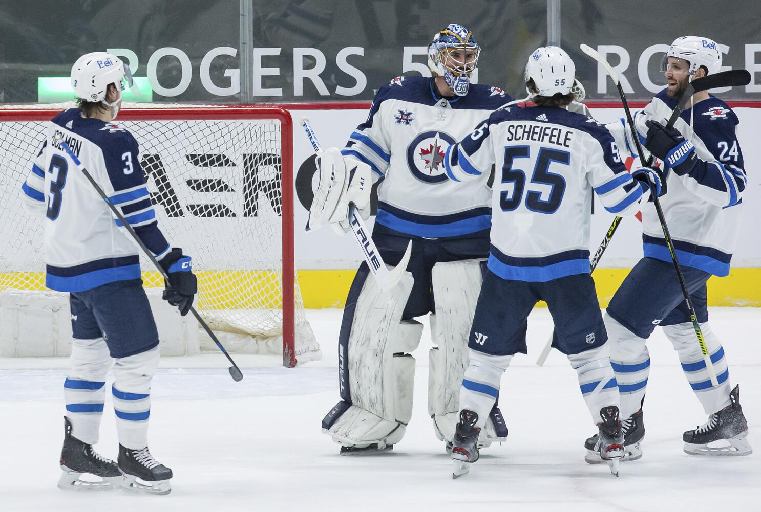 Hellebuyck posts 1st shutout of season, Jets top Canucks 4-0 - The San  Diego Union-Tribune