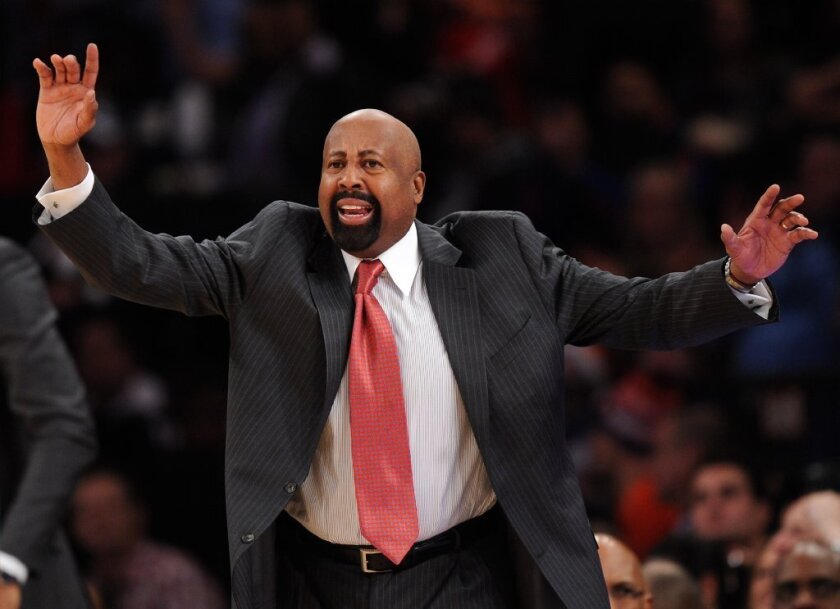 A demonstrative Mike Woodson yells to his team while coaching the New York Knicks.