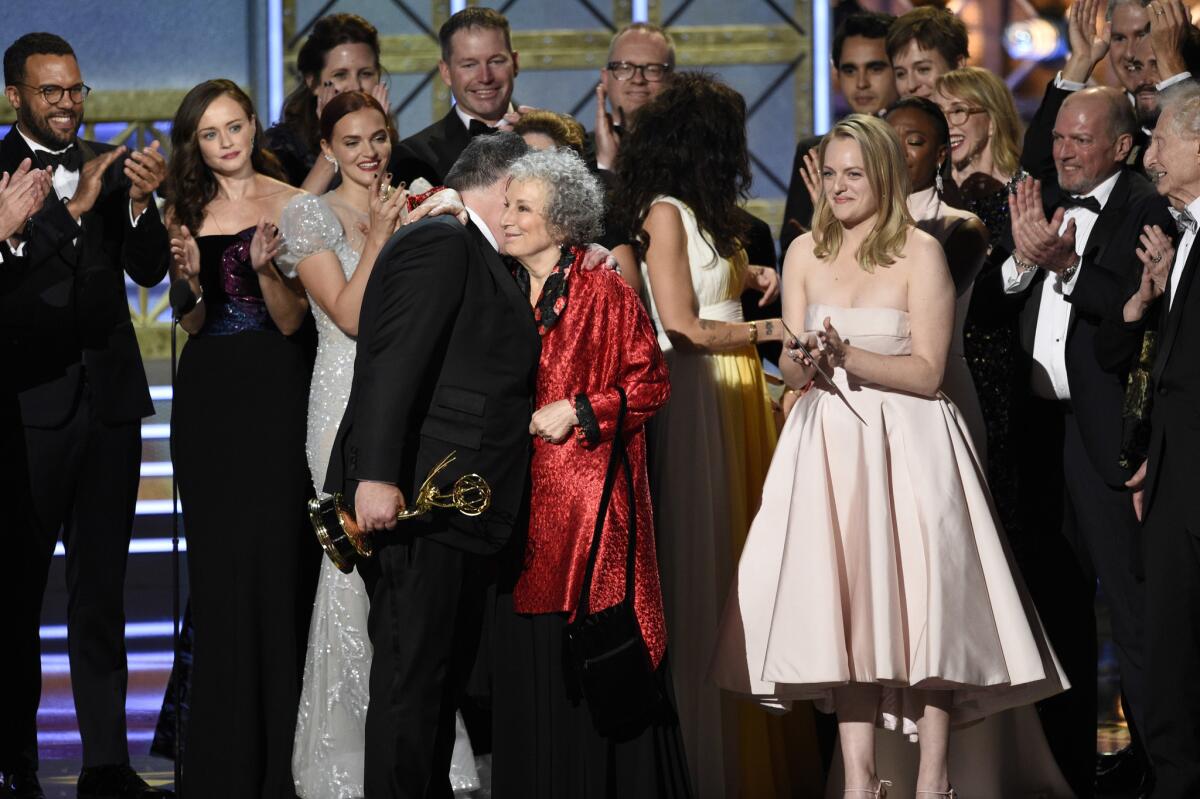 Bruce Miller, from left, Margaret Atwood and Elisabeth Moss accept the Emmy for drama series for "The Handmaid's Tale."