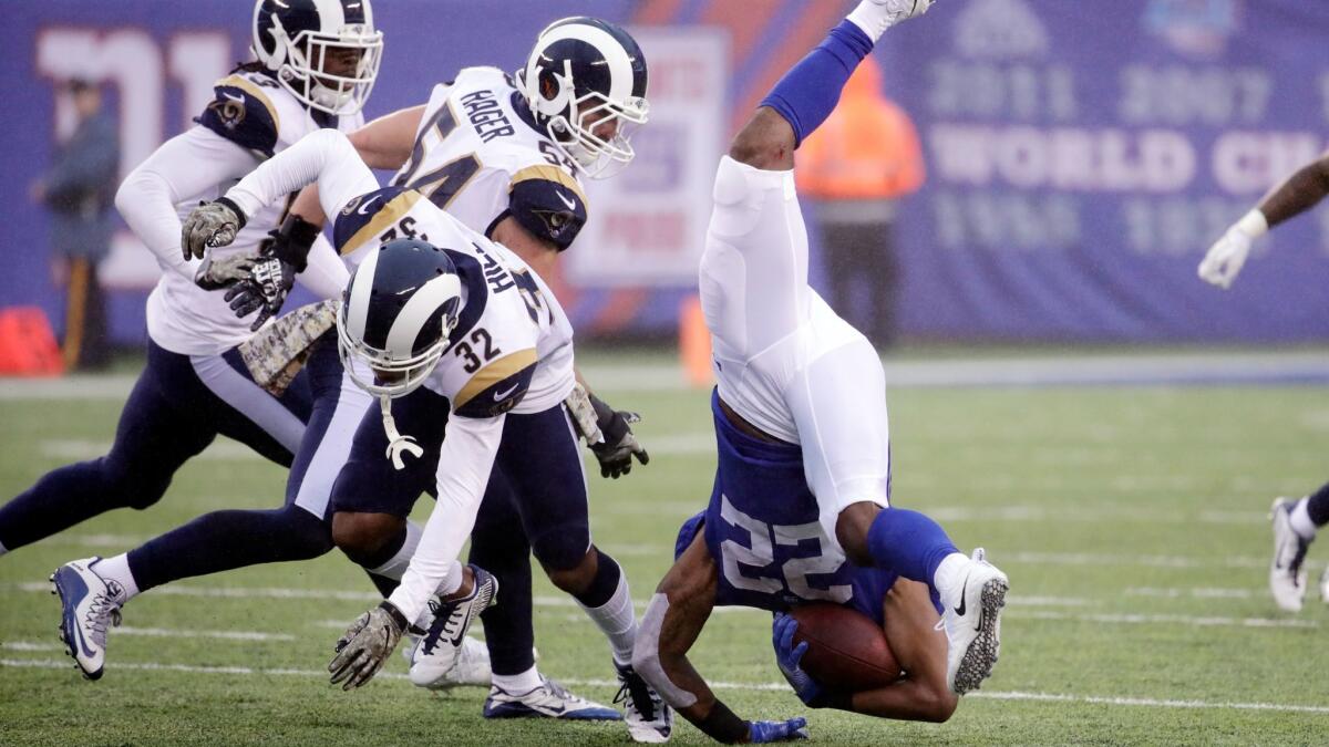 New York Giants' Wayne Gallman flips over Los Angeles Rams' Troy Hill.