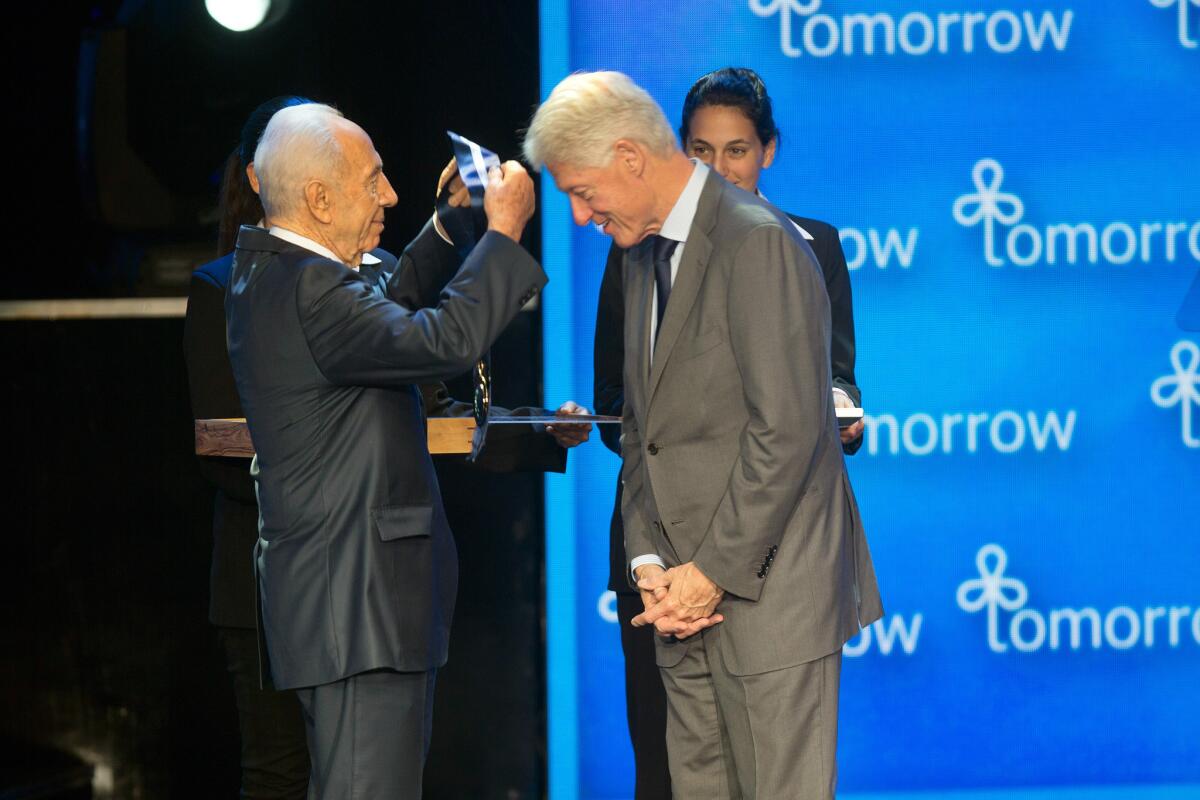 Israeli President Shimon Peres presents former President Bill Clinton with the presidential Medal of Freedom, Israel's highest distinction, Wednesday in Jerusalem.