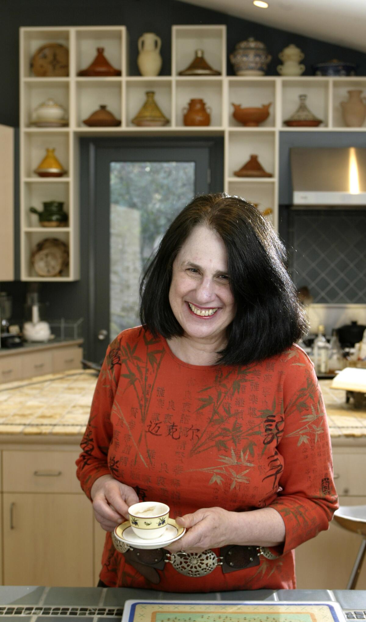 Paula Wolfert in her home kitchen with some of her favorite clay cooking pots.