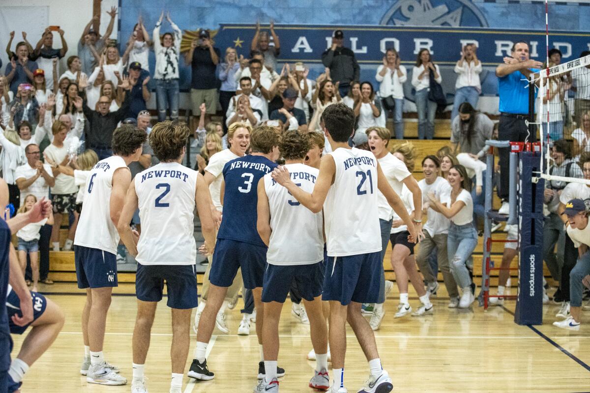 The Newport Harbor boys' volleyball team celebrates beating Los Alamitos in five sets on Tuesday.