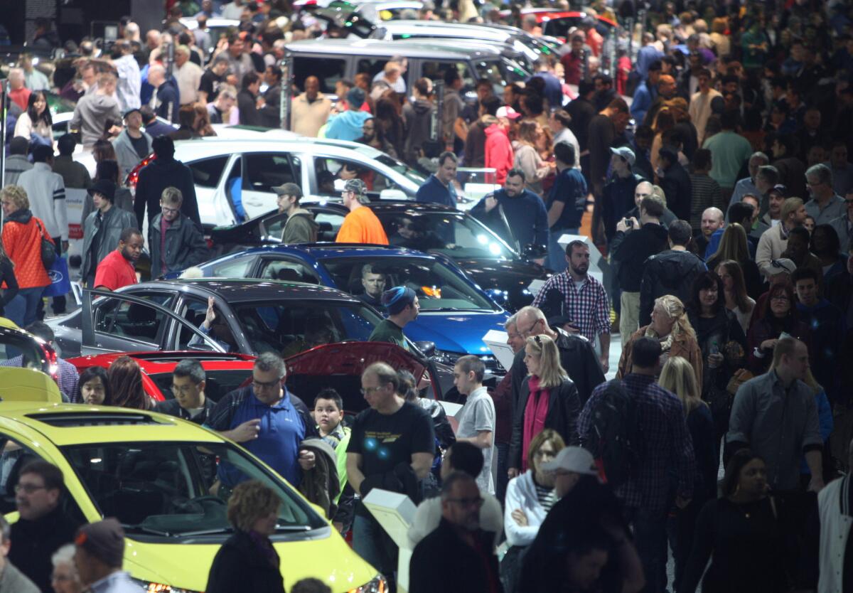 Visitors attend the North American International Auto Show at Cobo Center in Detroit on Jan. 17.