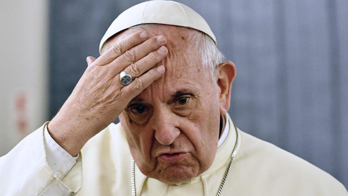 In this file picture taken in January, Pope Francis answers questions during a press conference on board a plane during a trip in which he visited Chile and Peru.