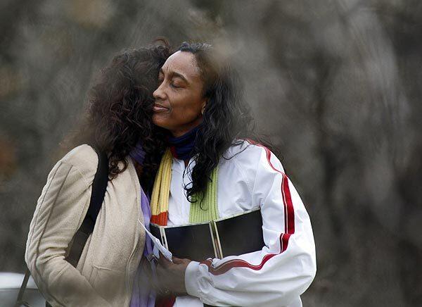 Latice Sutton, right, the mother of Mitrice Richardson, is comforted by a friend. More than 300 volunteers joined the Los Angeles County Sheriff's Department today to scour the Malibu Canyon area for traces of Richardson, who has been missing for nearly four months.