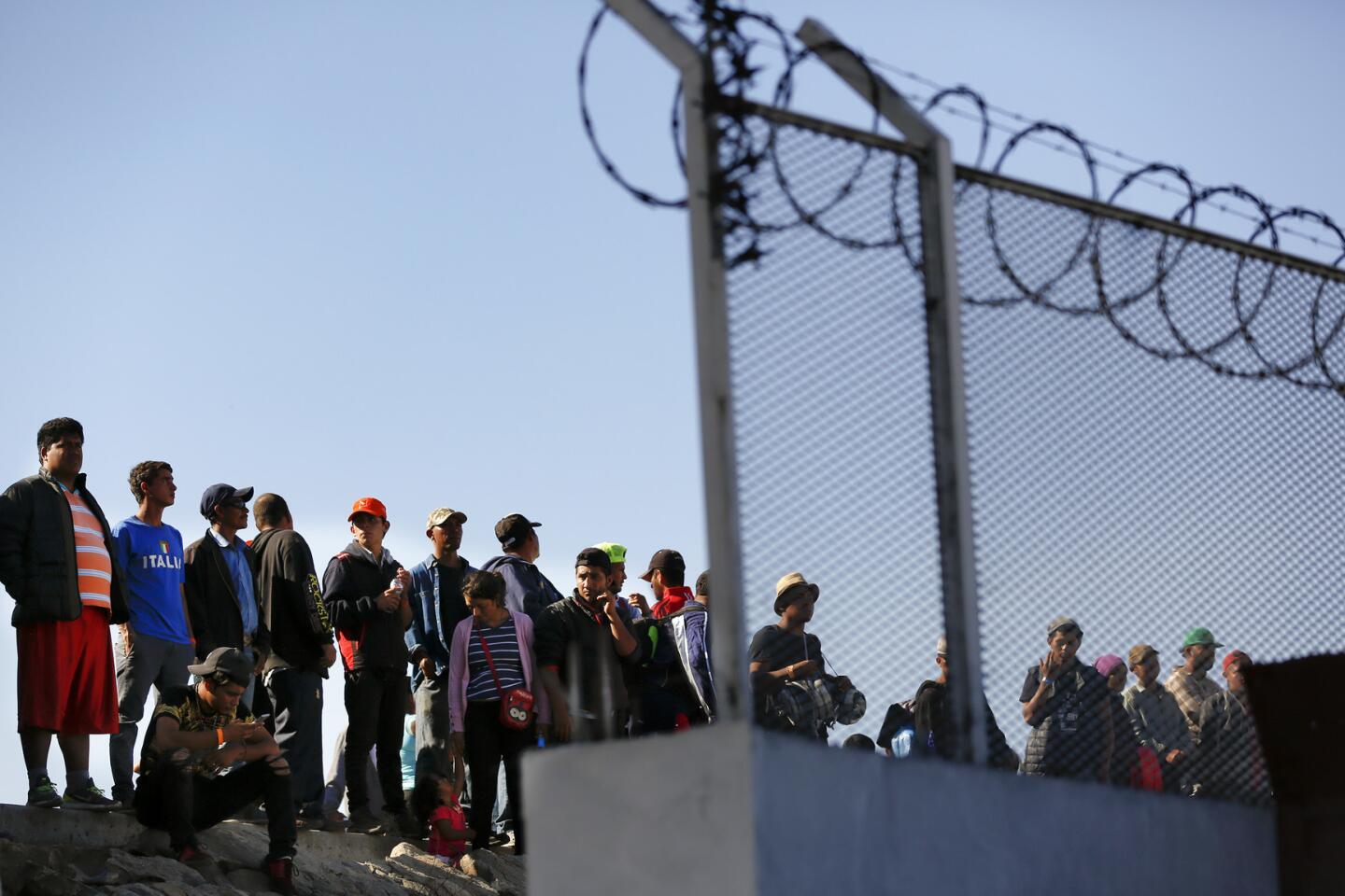 Central American migrant caravan reaches the border fence near San Ysidro