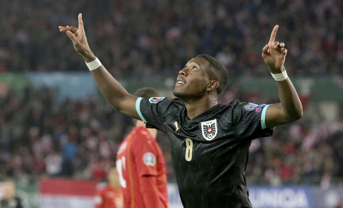 FILE - In this Saturday, Nov. 16, 2019 filer, Austria's David Alaba reacts after scoring during the Euro 2020 group G qualifying soccer match between Austria and North Macedonia at Ernst-Happel stadium in Vienna, Austria. (AP Photo/Ronald Zak)