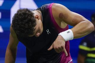Ben Shelton, of the United States, pantomimes hanging up a phone after defeating Frances Tiafoe