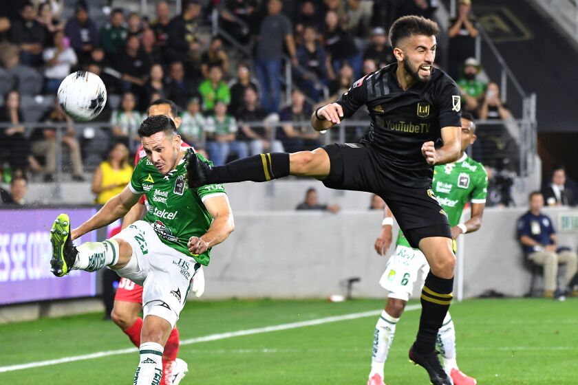 LOS ANGELES, CALIFORNIA FEBUARY 27, 2020-Leon's Ramiro Gonzalez kicks the ball away as LAFC's Diego Rossi tries to block it in the 1st half during the CONCACAF Champions League match at Banc of California Thursday. (Wally Skalij/Los Angeles Times)