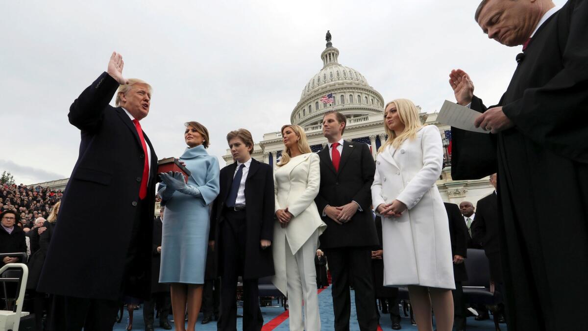 President Donald Trump takes the oath of office from Chief Justice John Roberts on Jan. 27 as his wife Melania holds the Bible and four of his children—Barron, Ivanka, Eric and Tiffany—look on.
