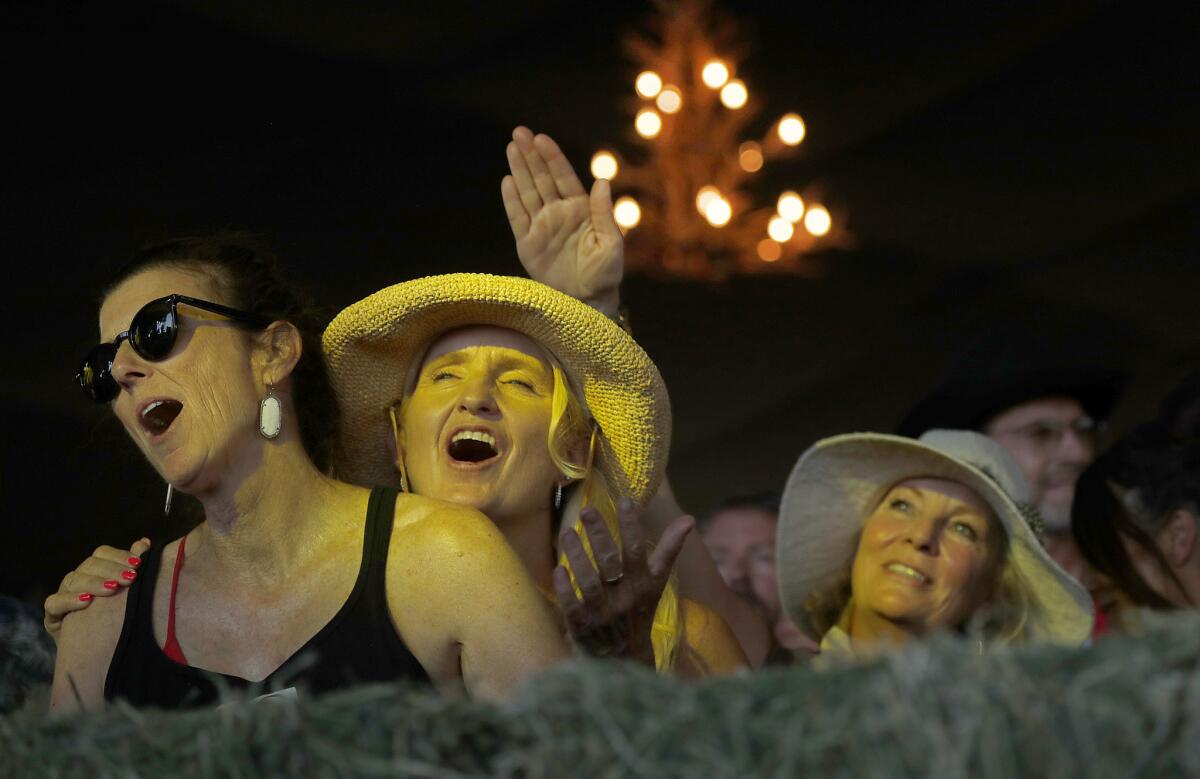 Fans sing along with Ronnie Milsap as he performs on the Palomino Stage.