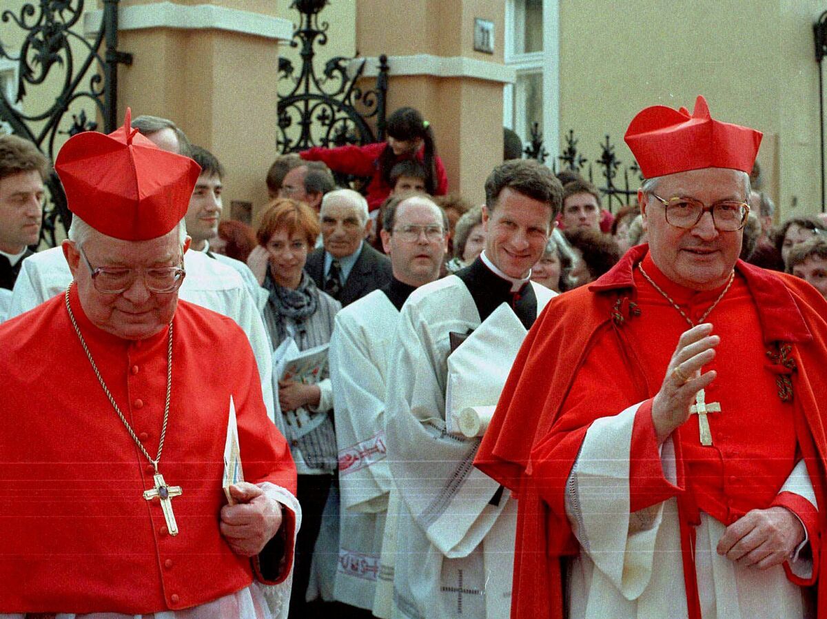 FILE - In this Sunday, May 25 1997 file photo, Wroclaw Metropolitan Cardinal, Henryk Gulbinowicz, left, and Legate of the Holy See Cardinal Angelo Sodano on their way to Wroclaw cathedral, in Poland. Polish media report on Tuesday, Nov, 10, 2020 that a prominent Polish cardinal recently sanctioned by the Vatican is hospitalized and unconscious. The 97-year-old retired Archbishop Henryk Gulbinowicz was sanctioned by the Vatican last week after he was accused of sexually abusing a seminarian and of covering up abuse in another case. (AP Photo/Adam Hawalej, file)