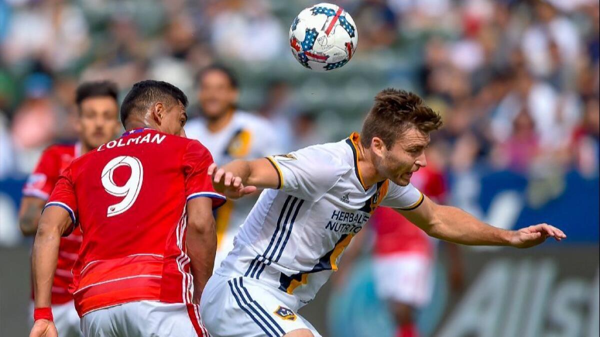 Galaxy defender Dave Romney, right, and FC Dallas forward Cristian Colman vie for the ball during Saturday's game at StubHub Center.