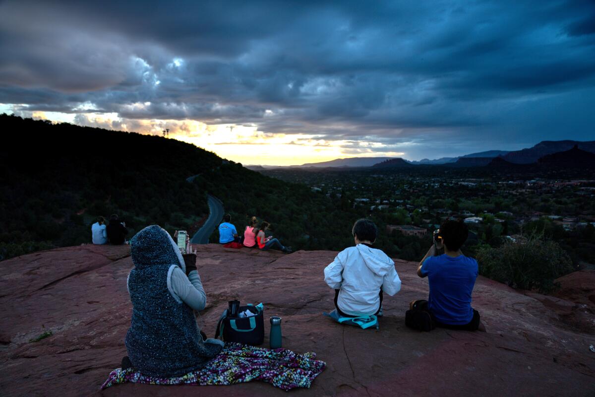 People sit and watch the sunset 