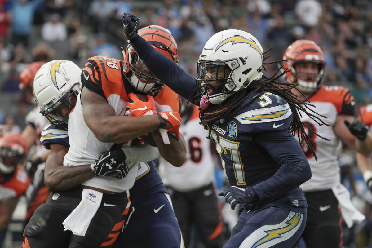 Chargers safety Jahleel Addae celebrates as Cincinnati Bengals running back Joe Mixon is stopped short of a first down.