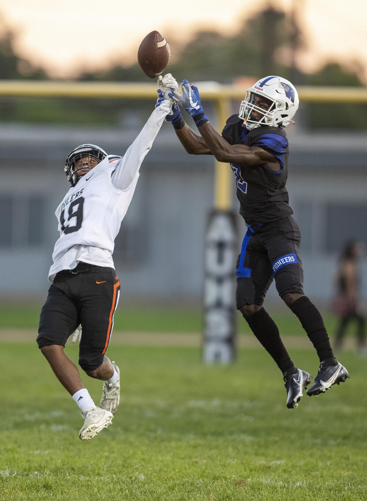 Huntington Beach's Quincy Hankins breaks up a pass intended for Western's Drew Faulkner during a nonleague game on Thursday.