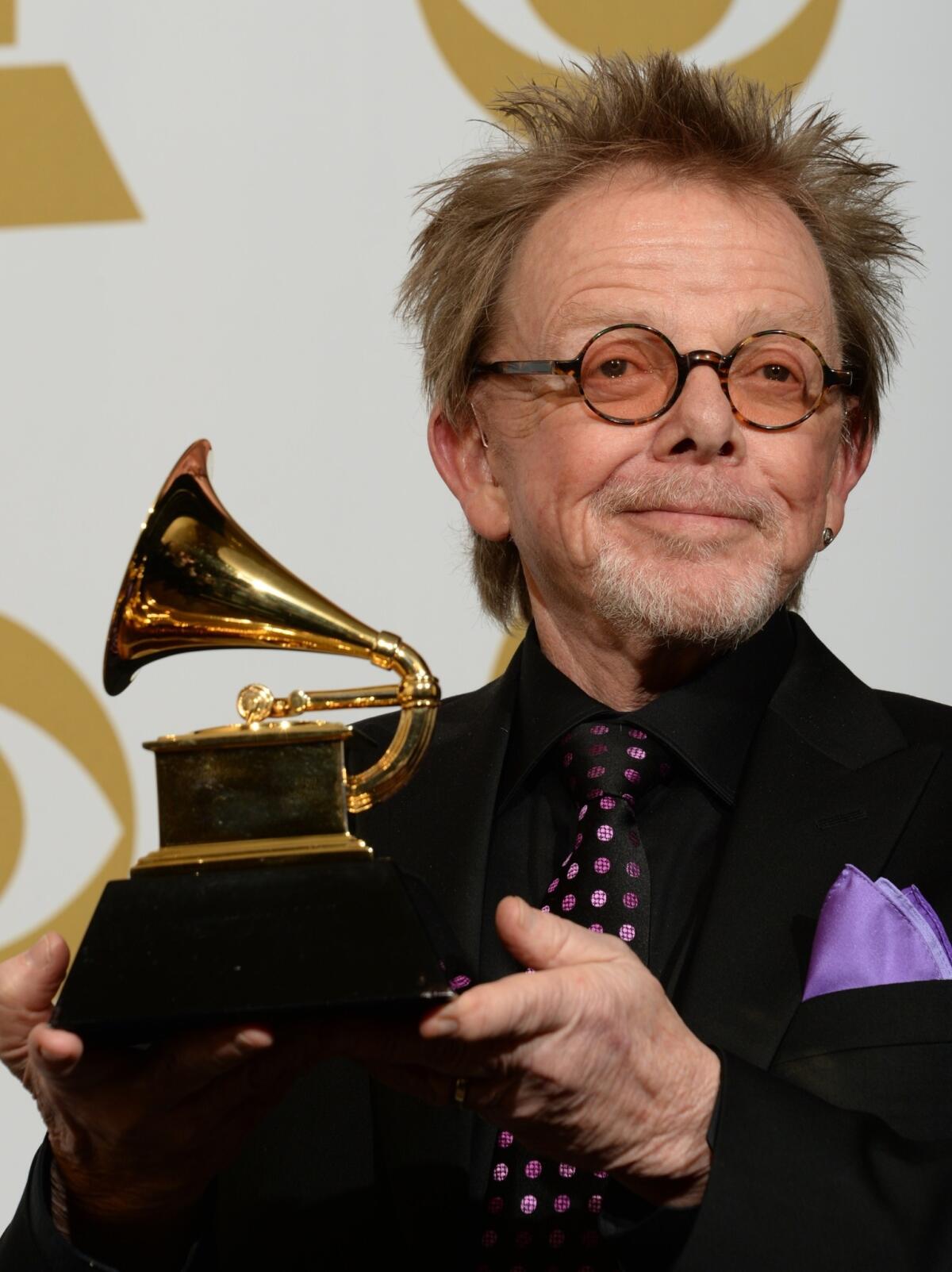 Paul Williams, who partnered with Daft Punk, poses in the press room with his Album of the Year award for "Random Access Memories" during the 56th Grammy Awards at the Staples Center on Jan. 26.
