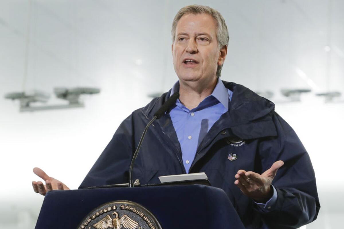 New York City Mayor Bill de Blasio speaks at a lectern