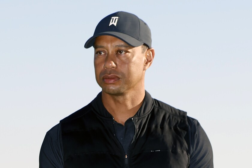 FILE - Tiger Woods looks on during the trophy ceremony on the practice green after the final round of the Genesis Invitational golf tournament at Riviera Country Club, Sunday, Feb. 21, 2021, in the Pacific Palisades area of Los Angeles. Woods was injured Tuesday, Feb. 23, 2021, in a vehicle rollover in Los Angeles County and had to be extricated from the vehicle with the “jaws of life” tools, the Los Angeles County Sheriff’s Department said.(AP Photo/Ryan Kang)
