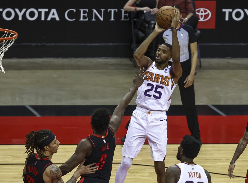 Phoenix Suns forward Mikal Bridges (25) shoots against the Houston Rockets during the fourth quarter of an NBA basketball game in Houston, Monday, April 5, 2021. (Troy Taormina/Pool Photo via AP)