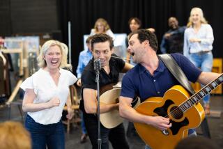 Actors rehearsing in front of a microphone for a Johnny Cash musical.
