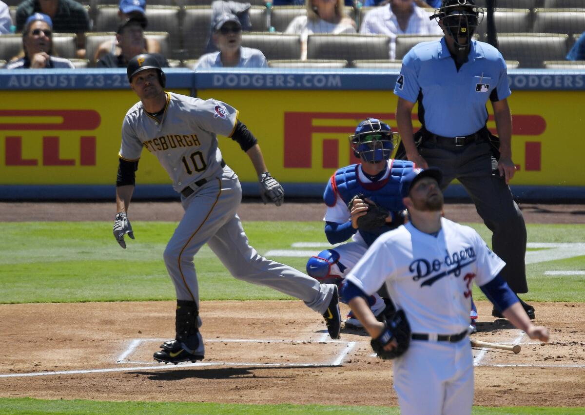 Pirates infielder Jordy Mercer runs to first after hitting a two-run home run against Dodgers starting pitcher Brett Anderson, lower right, during the first inning.