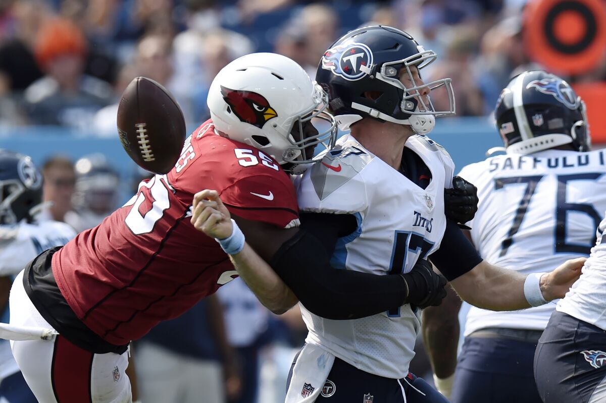 Arizona Cardinals linebacker Chandler Jones (55) sacks Tennessee Titans quarterback Ryan Tannehill (17) and forces a fumble that the Cardinals recovered in the second half of an NFL football game Sunday, Sept. 12, 2021, in Nashville, Tenn. (AP Photo/Mark Zaleski)