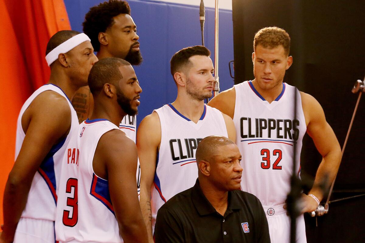Clippers Coach Doc Rivers sits in front of Paul Pierce, left, Chris Paul, DeAndre Jordan, J.J. Redick and Blake Griffin during media day.