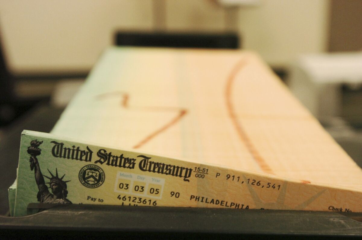 In this Feb. 11, 2005 file photo, trays of printed social security checks wait to be mailed from the U.S. Treasury's Financial Management services facility in Philadelphia.