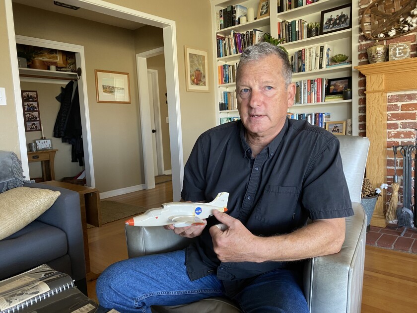Bird Rock resident David Everett demonstrates how his father, test pilot Lou Everett, lost his life using a model of the experimental plane his father flew 54 years ago.