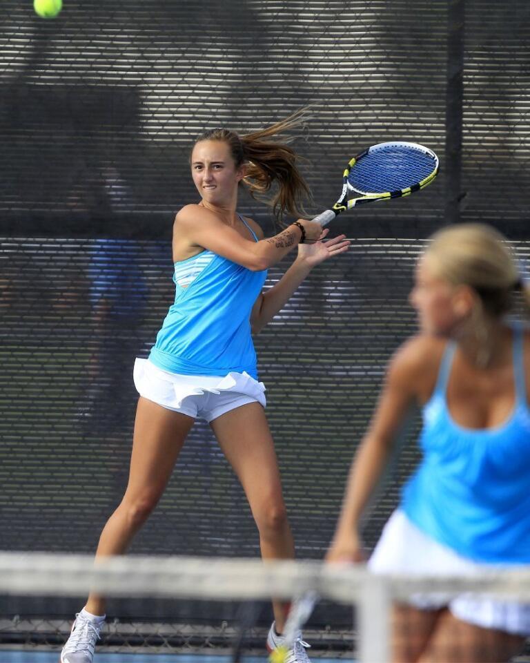 Corona del Mar High's Jasie Dunk, left, returns a volley during a doubles match, with partner Siena Sharf, right, against Peninsula on Wednesday.