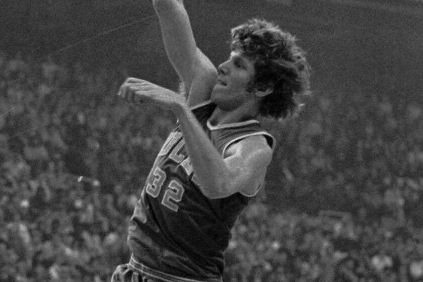 ADVANCE FOR WEEKEND EDITIONS MARCH 6–7––FILE––UCLA center Bill Walton shoots for two of his record 44 points against Memphis State in final game of the NCAA Tournament in St. Louis, in this March 27 1973 photo. An 87–66 blowout for the Bruins was payback for the sub–par championship game performance of the year before. It seemed so easy when it was happening, but Walton had some problems of his own with the officials. He drew three personal fouls and was forced to the bench in the first half. And he was called seven times for goaltending, four of them on offense.(AP Photo/FILE)