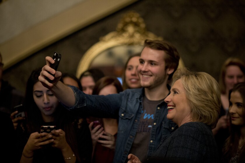 Democratic presidential candidate Hillary Clinton takes a selfie with a supporter after a rally Tuesday in Sioux City, Iowa.