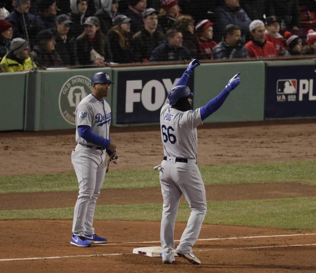 Dodgers' Yasiel Puig celebrates after hitting a single to score a run.