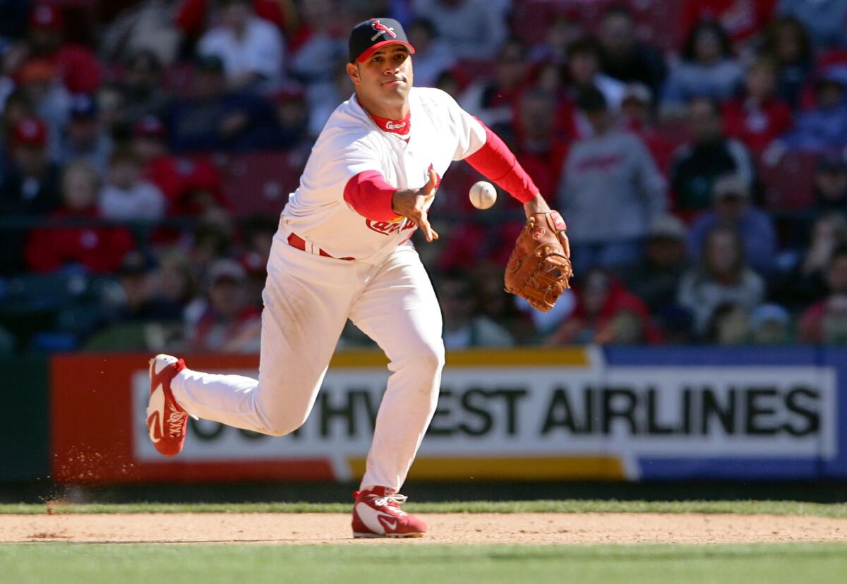 St. Louis Cardinals first baseman Albert Pujols tosses the ball during a game against the Houston Astros in April 2005.