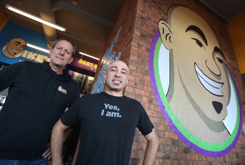 CEO Michael Goldberg and owner-founder Ike Shehadeh from left, at a new Ike's Love and Sandwiches in Costa Mesa Friday. 
