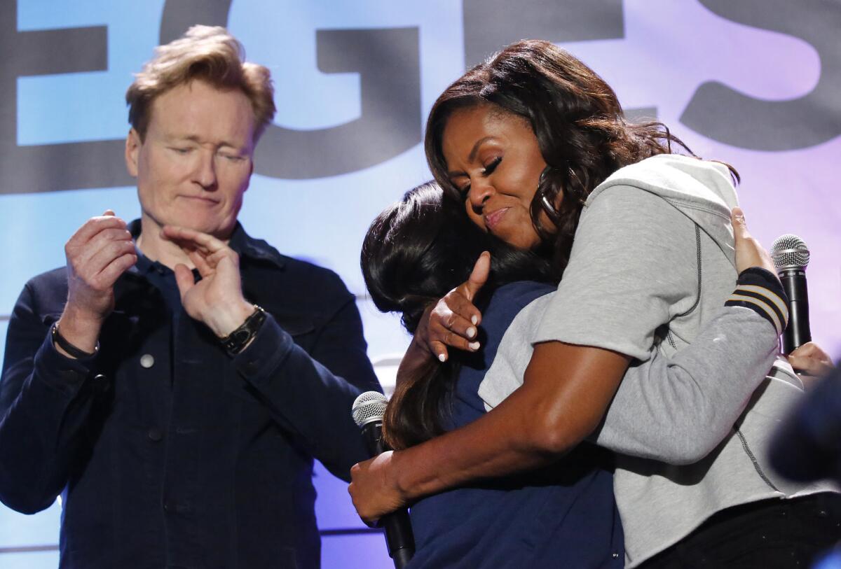 Michelle Obama hugs Taahira Bholat, a senior at Lawndale High School who will be attending El Camino College.