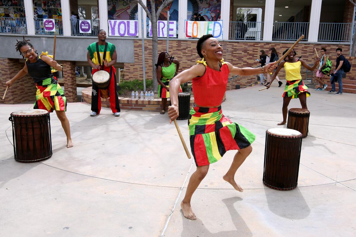 African Soul International members, from left, Monique Thompson, SaNu Baraka, Jewel Jackson, Nayre Blake and Isatu N'Diaye, played the drums during Black History Month Celebration at Hoover High School on Feb. 28.